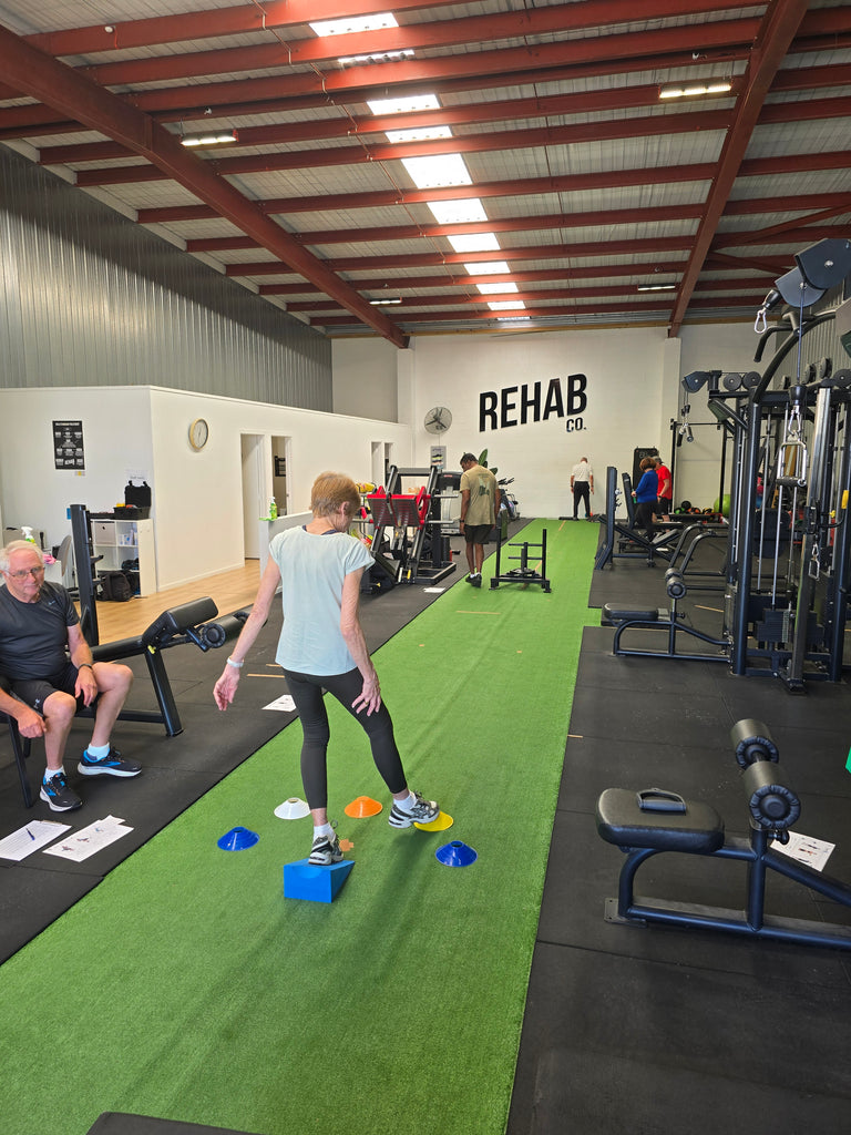 Senior individuals engaging in balance training exercises as part of RehabCo Physio's Grey Matters programme in Auckland