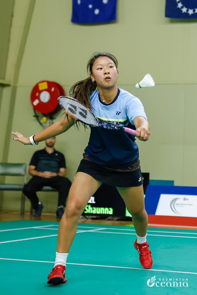 Female badminton player taking a shot