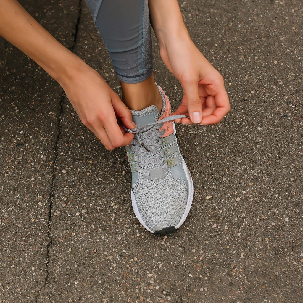 Person tying shoe